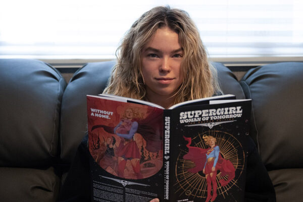 Milly Alcock reading the Supergirl: Woman of Tomorrow comic book