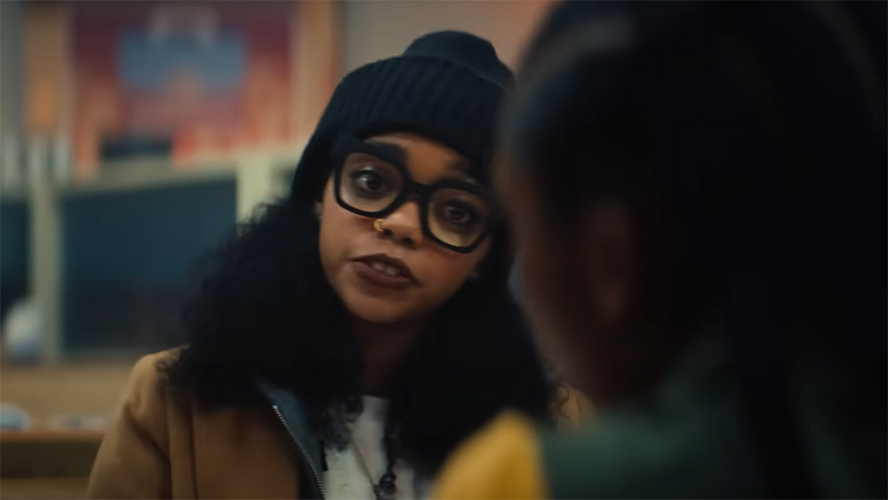 Zelma sitting at a table and looking at Riri in Marvel's Ironheart TV show