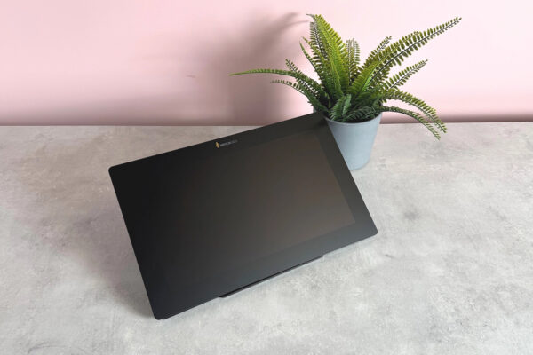 The Xencelabs Pen Display 16 with a blank screen at a 3/4s angle in front of a pot plant.