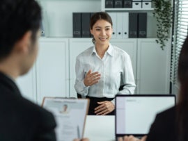 Top 5 Skills Entry-Level Cybersecurity Professionals Need Asian beautiful woman talk with hr manager for job interview in office.