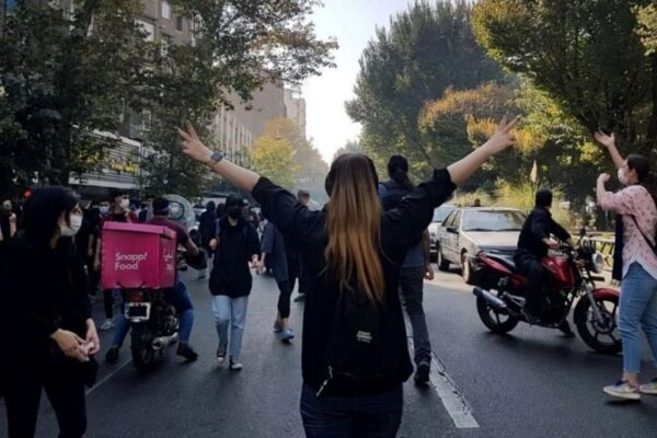 Protesters block a road during a protest over the death of young Iranian woman