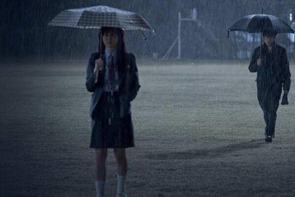 Characters standing in the rain in Nine Puzzles