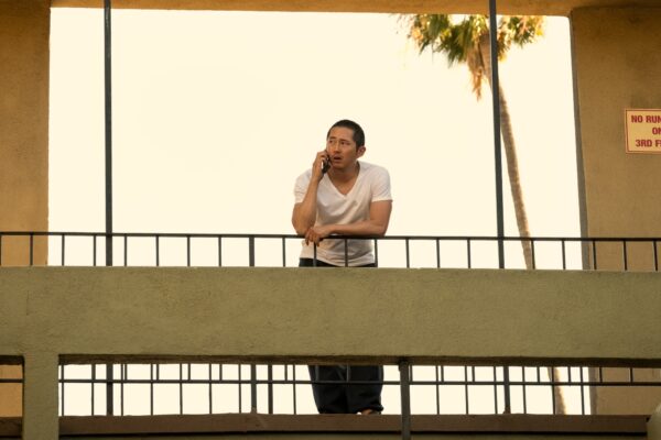 Danny stands on a balcony talking on the phone in Beef season 1